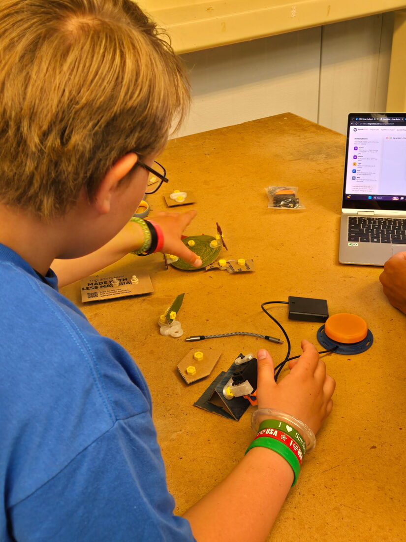 A camper operating their SparkServo build with the SparkBuild app